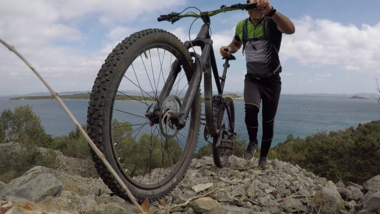 a man with a mountain bike on a hill